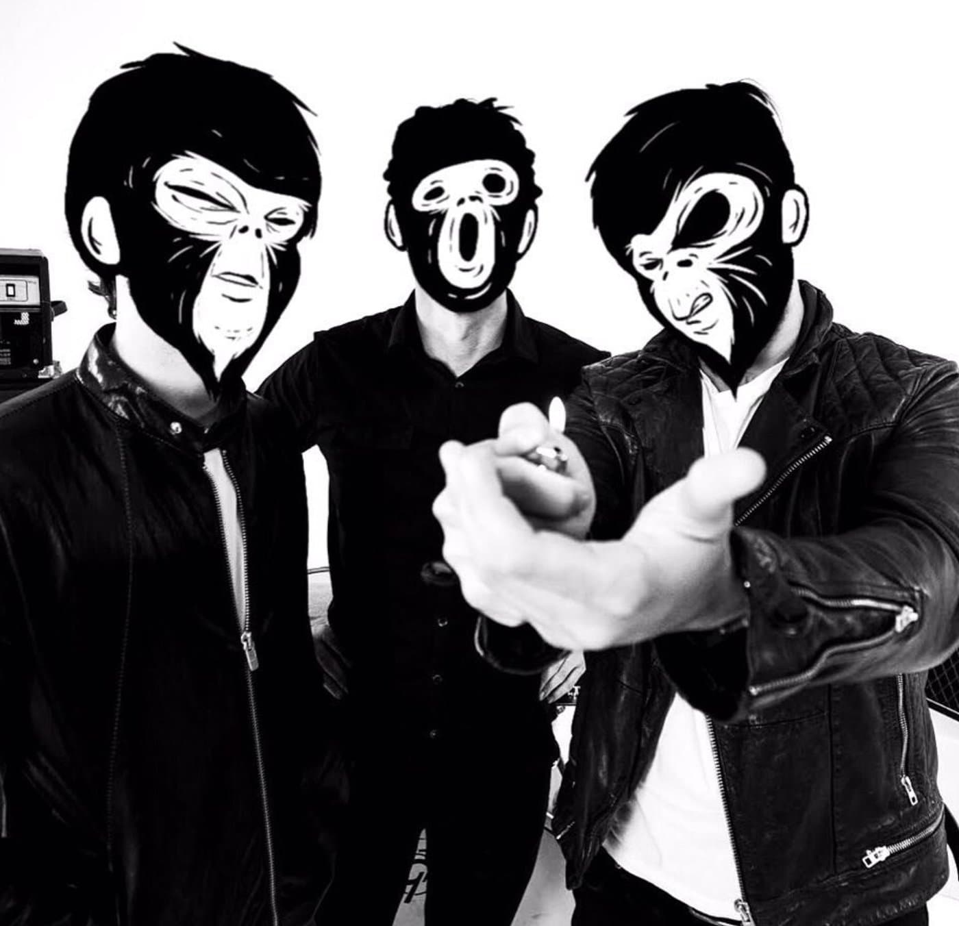 The trio in leather jackets, faces covered by hand-drawn monkey masks, one holding out a lighter