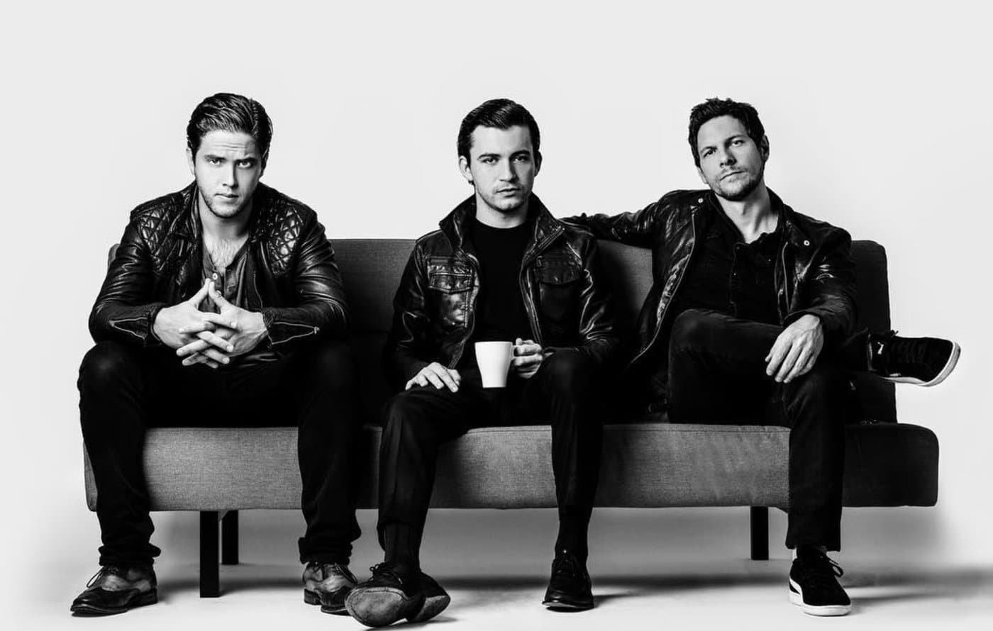 Rodrigo, Luis, and Carlos on a sofa — black and white press photo