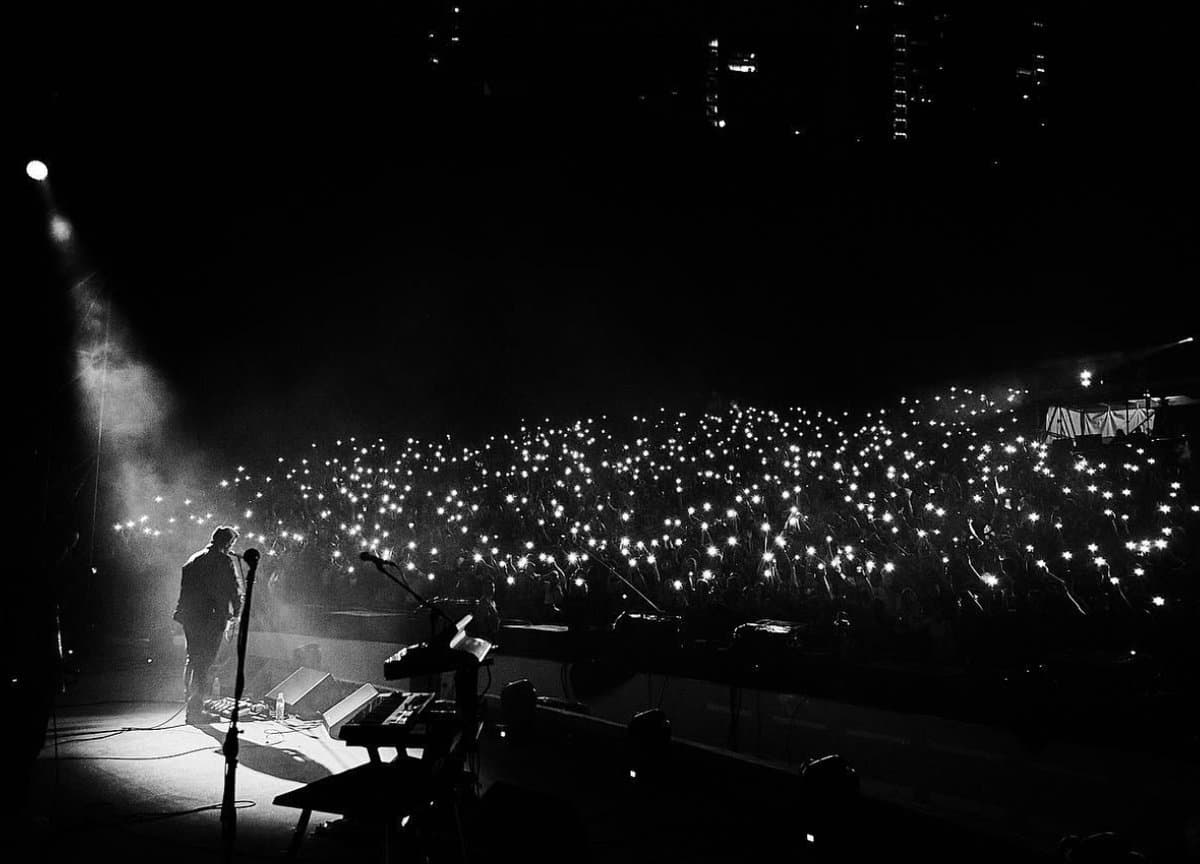 A sea of phone lights in the dark
